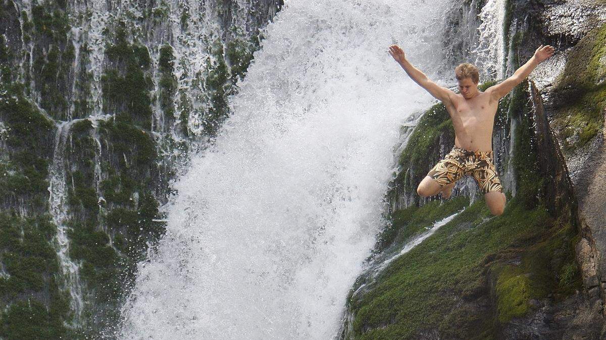 In this 2008 file photo, a 21-year-old man leaps from the 45-foot ledge into the pool at Elk Falls on the Elk River in
Avery  County. The U.S. Forest Service urged people to avoid the falls on Memorial Day weekend, 2018, as treacherous waters forced a  search for a body to be suspended last week. A body believed to be that of 26-year-old Thomas McCardle Jr. surfaced on Wednesday, the sheriff's office said.