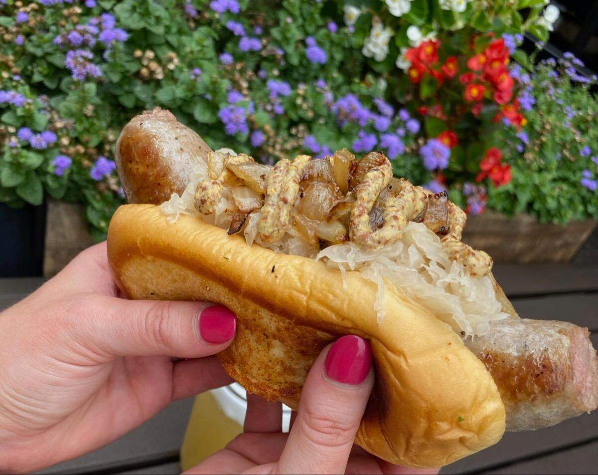 A Carolina Butcher and Beer Garden Beergarden Brat comes topped with sauerkraut, sauteed onions and spicy mustard ($8.99).