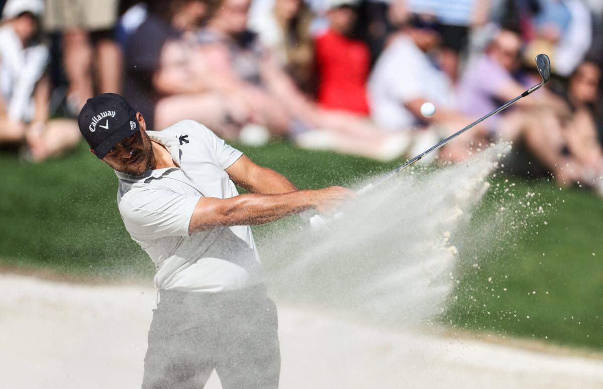 Xander Schauffele hits from a bunker on the 15th hole during round three of the Wells Fargo Championship at Quail Hollow Club in Charlotte, N.C., on Saturday, May 11, 2024.
