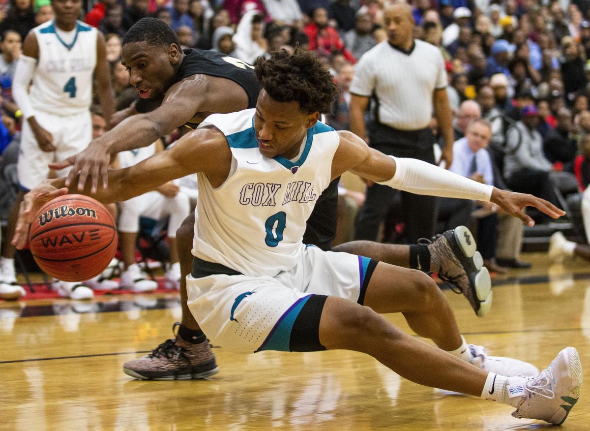 Cox Mill’s Wendell Moore, right, tries to keep the ball in bounds against West Charlotte’s Cartier Jernigan during the Charlotte Hoops Challenge at Berry High School on November 15, 2018 in Charlotte, North Carolina.