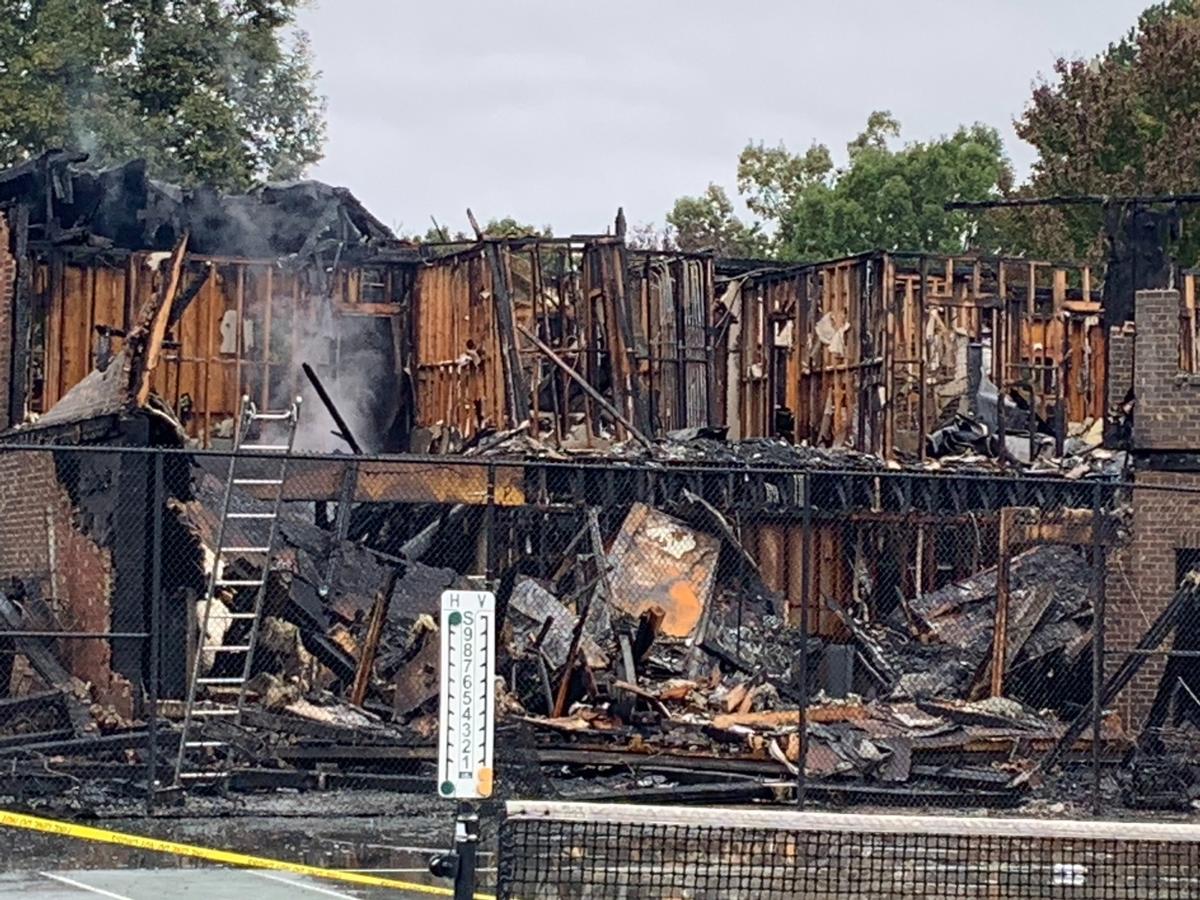 In a photo taken about eight hours after the fire began, a bit of smoke still rises from The Club at Westport facility in Denver, N.C. The club burned down on Oct. 9, 2020.