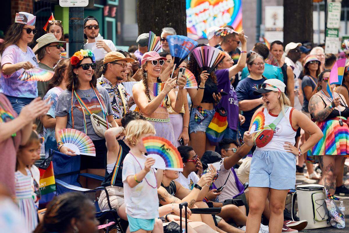 Spectators cheer on passing parade floats as the crowds swell during the 25th Charlotte Pride Parade in uptown Charlotte on August 17, 2025.