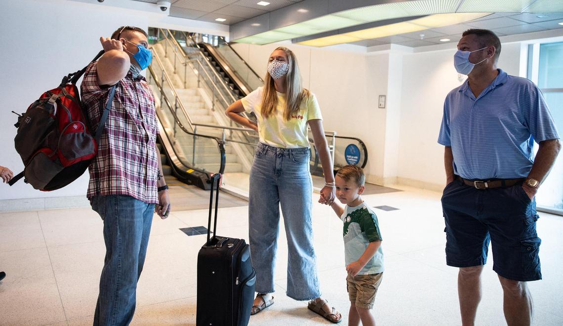 Ryan Krok, left, waits for the elevator at the airport by his sister, Natalie Friedl, her son, Kent and her husband, Alan, in Charlotte, N.C., on Thursday, August 5, 2021.
