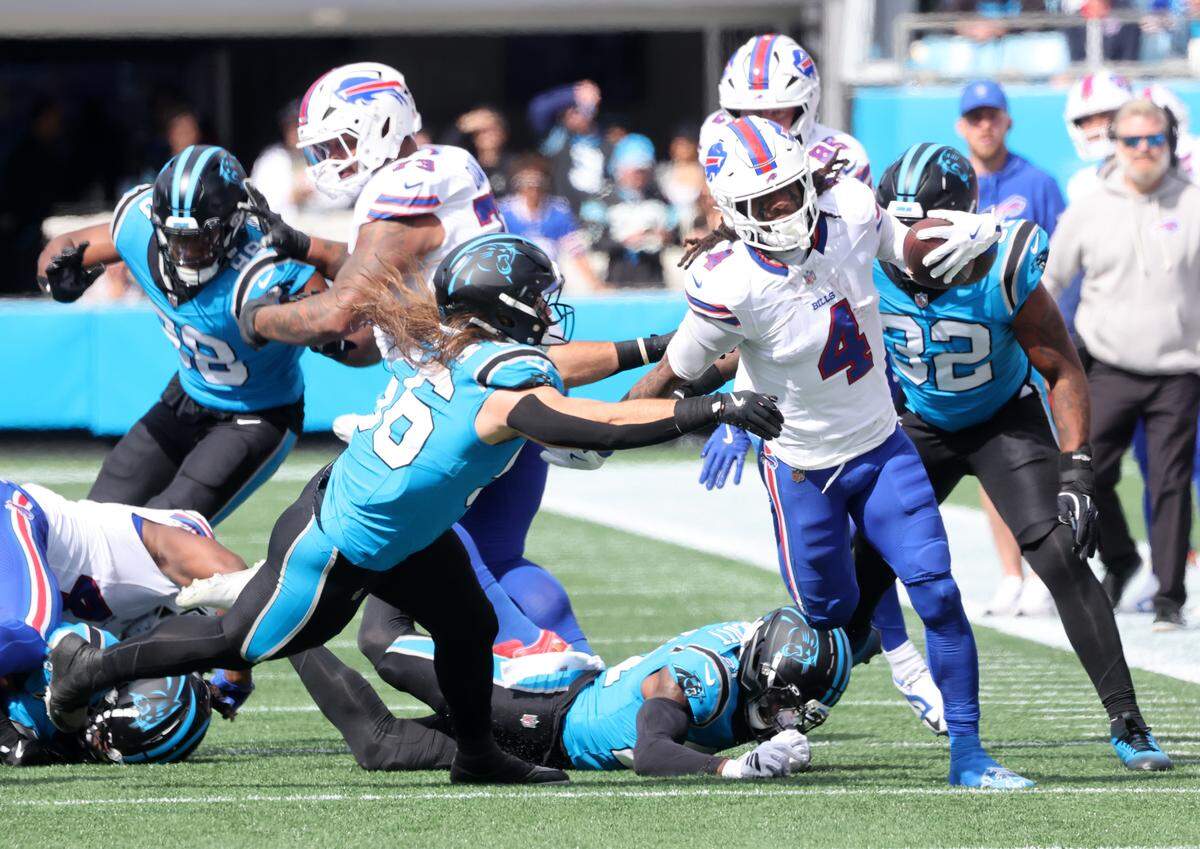 Carolina Panthers' Christian Rozeboom (56) tries to stop Buffalo Bills' James Cook on Oct. 26, 2025 at Bank of America Stadium in Charlotte.