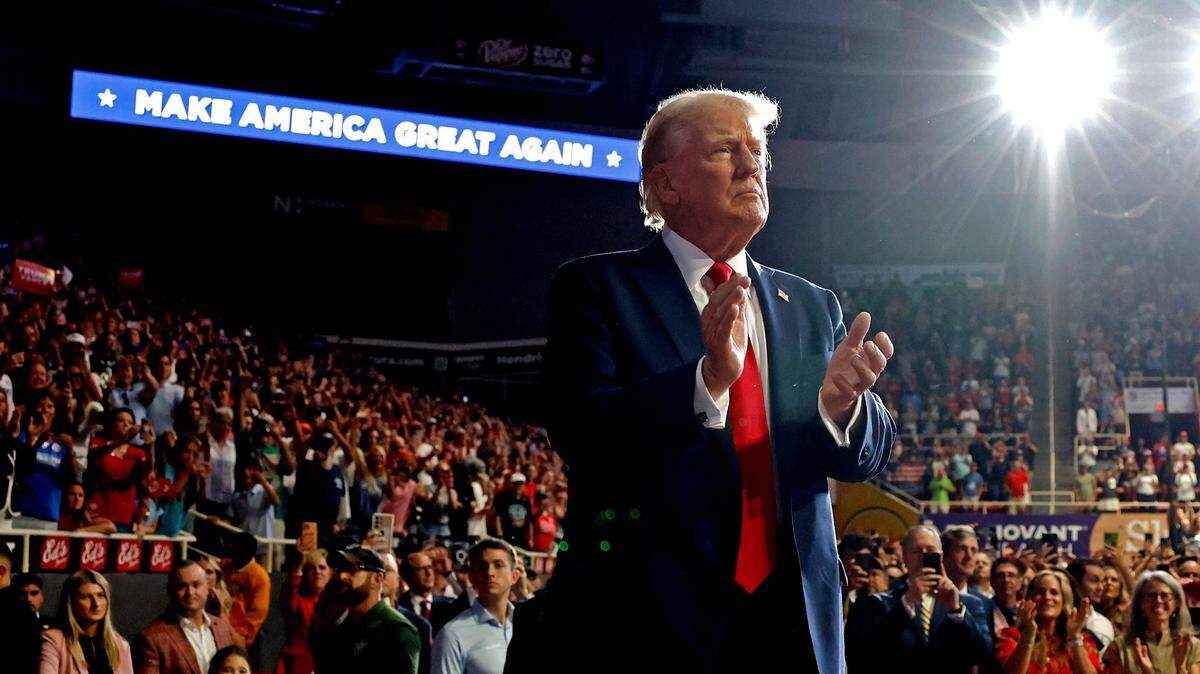 Former President Donald Trump claps with supporters during a campaign rally at Bojangles Coliseum in Charlotte, NC on Wednesday, July 24, 2024.