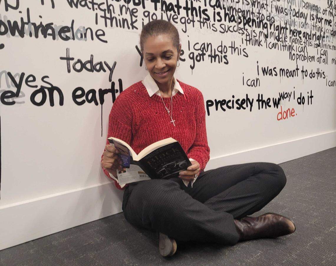 Lisa Vernon-Sparks with the book “Black Fortunes” by Shomari Wills.