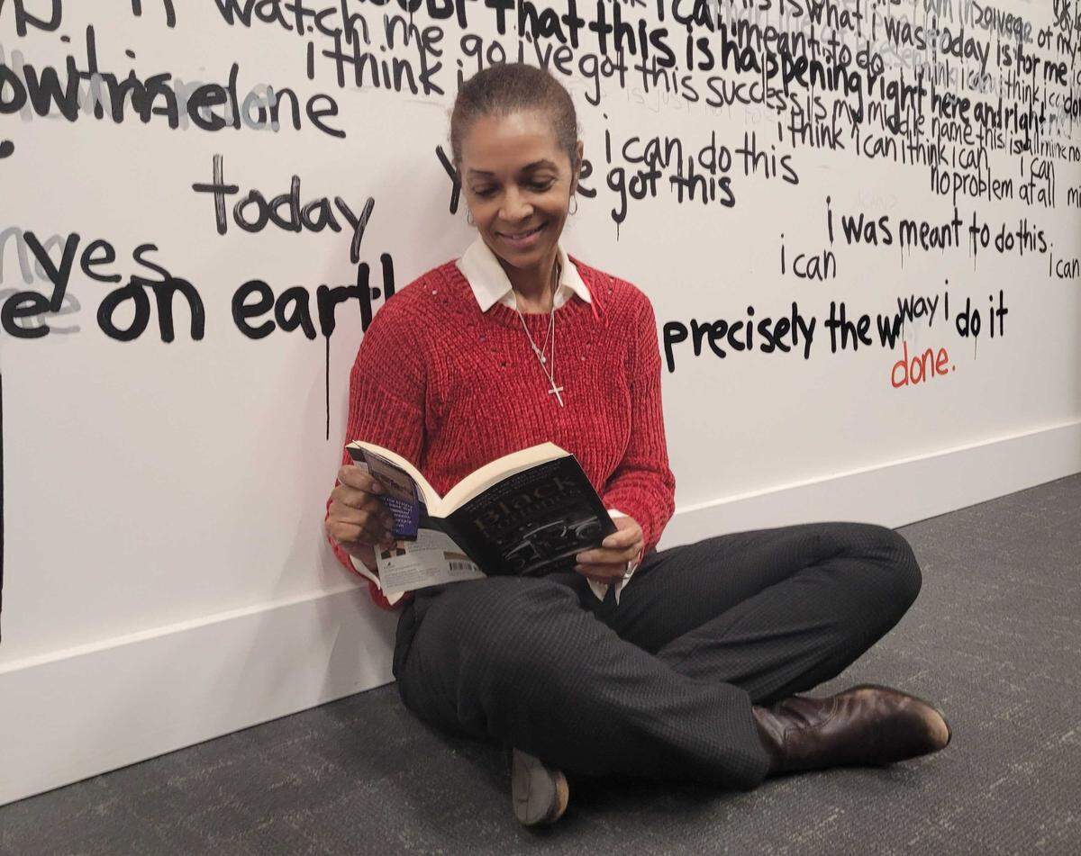 Lisa Vernon-Sparks with the book “Black Fortunes” by Shomari Wills.