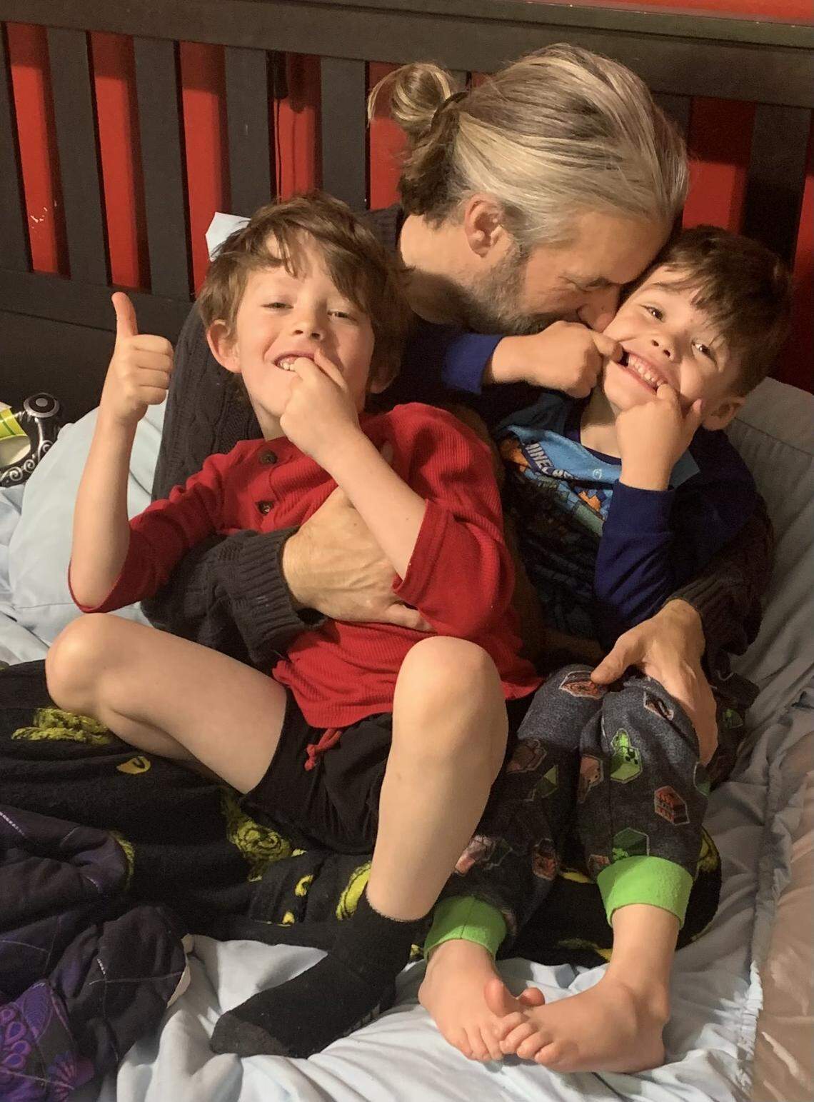 Lance Wisely gives bedtime snuggles to his sons Felix and Lucas.