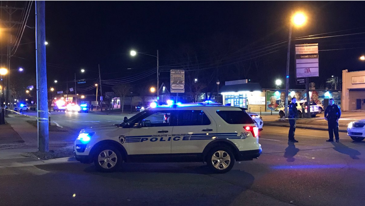 CMPD officers at the scene of a Christmas morning shooting that left one person dead and two injured off Beatties Ford Road in Charlotte.
