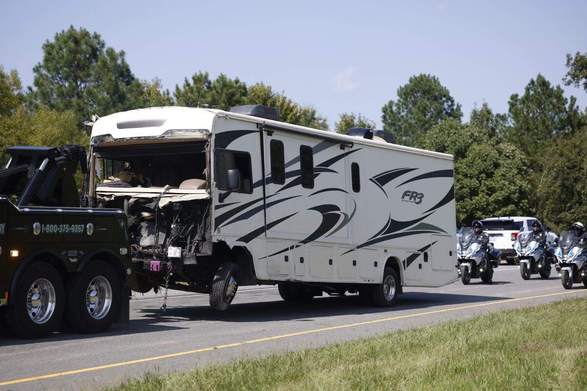 The camper is towed away after it struck a vehicle and also crashed into two police vehicles on the shoulder of the Interstate 485 off ramp at Mt. Holly Road Thursday, Aug. 22, 2024.