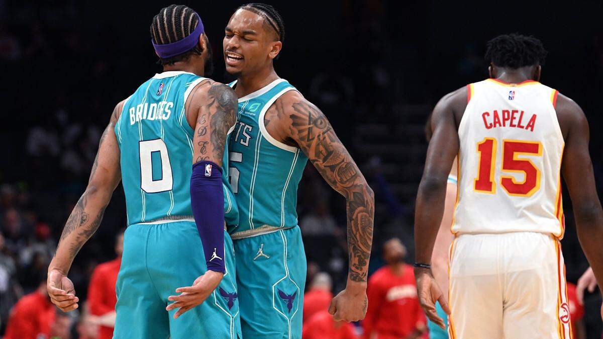 Charlotte Hornets forwards Miles Bridges, left and PJ Washington, right, celebrate the teamÕs play against the Atlanta Hawks during first half action at Spectrum Center in Charlotte, NC on Wednesday, March 16, 2022.