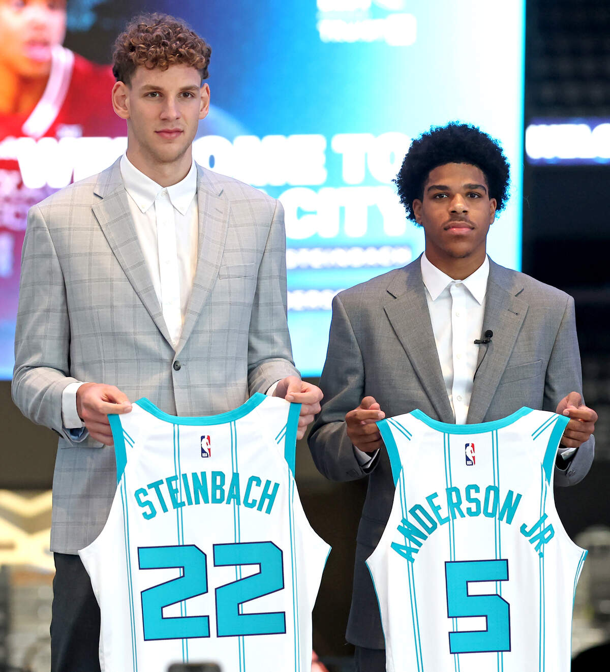 Charlotte Hornets draft picks Hannes Steinbach (left) and Christian Anderson display their jerseys during their introductory press conference at Spectrum Center in Charlotte Thursday.