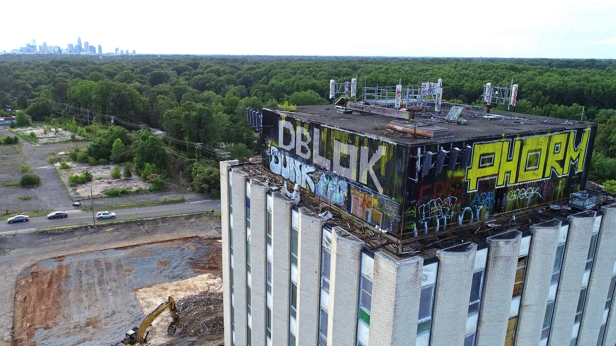 Graffiti wraps the upper level of the Ervin/Varnadore Building on Independence Boulevard in Charlotte, on Tuesday, June 8, 2021. There is potential of the building being dedicated as a historic landmark.