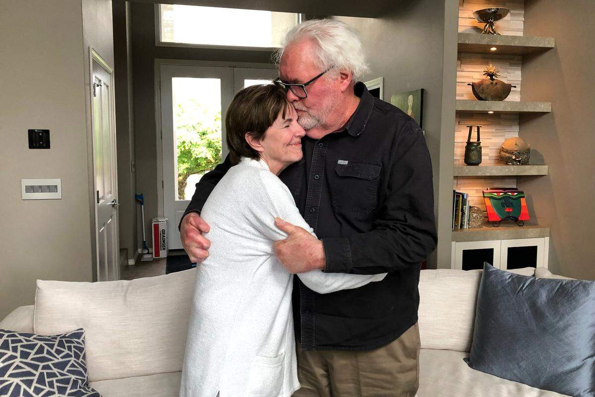 Eastern Flight 212 survivor Richard Arnold, right, kisses his wife, Catherine at their home in Camas, Washington. Arnold, now 81, was 31 at the time of the plane crash in 1974.