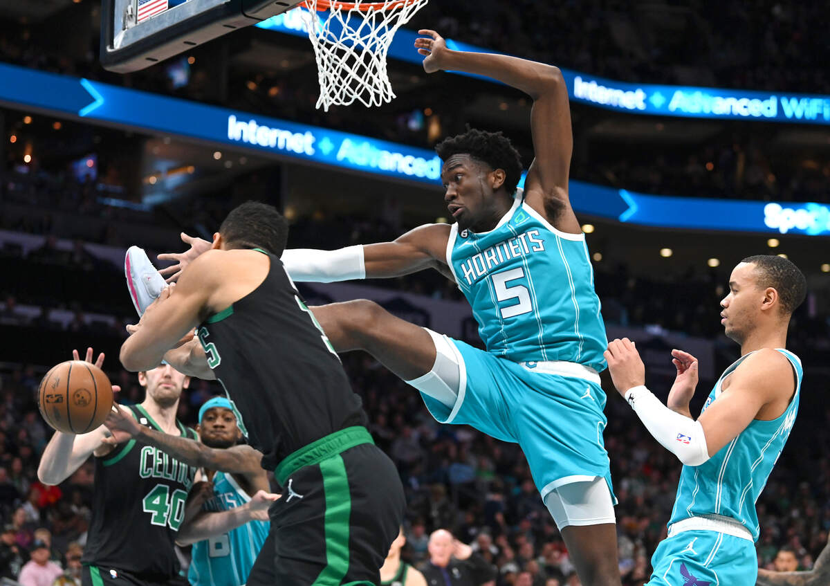 Charlotte Hornets center Mark Williams, center, attempts to stop a pass across the lane by the Boston Celtics during second half action at Spectrum Center in Charlotte, NC on Monday, January 16, 2023. The Celtics defeated the Hornets 130-118.