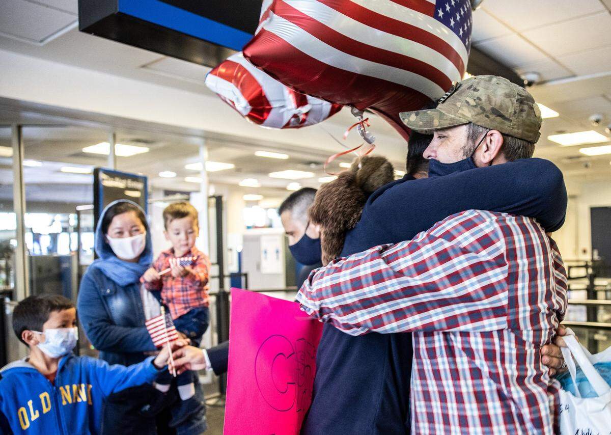 U.S. veteran Sean Kilbane, right, hugs Hamid as he arrives at the Charlotte Douglas International Airport in Charlotte, on Nov. 9, 2021.