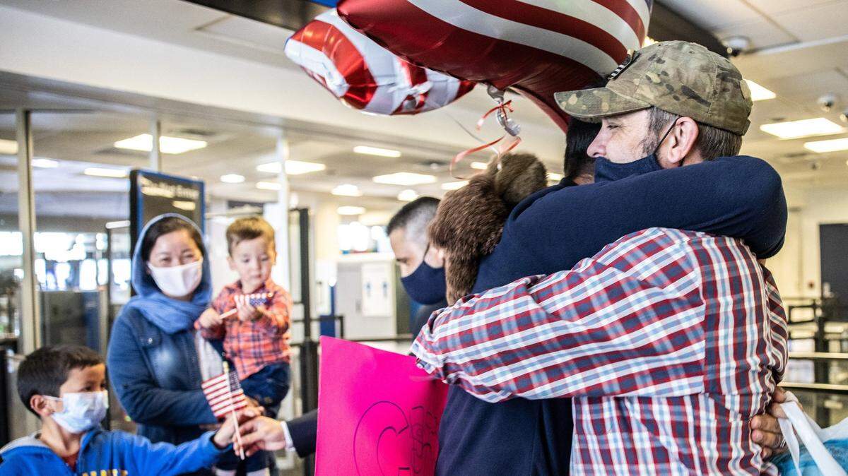 U.S. veteran Sean Kilbane, right, hugs Hamid as he arrives at the Charlotte Douglas International Airport in Charlotte, on Nov. 9, 2021.