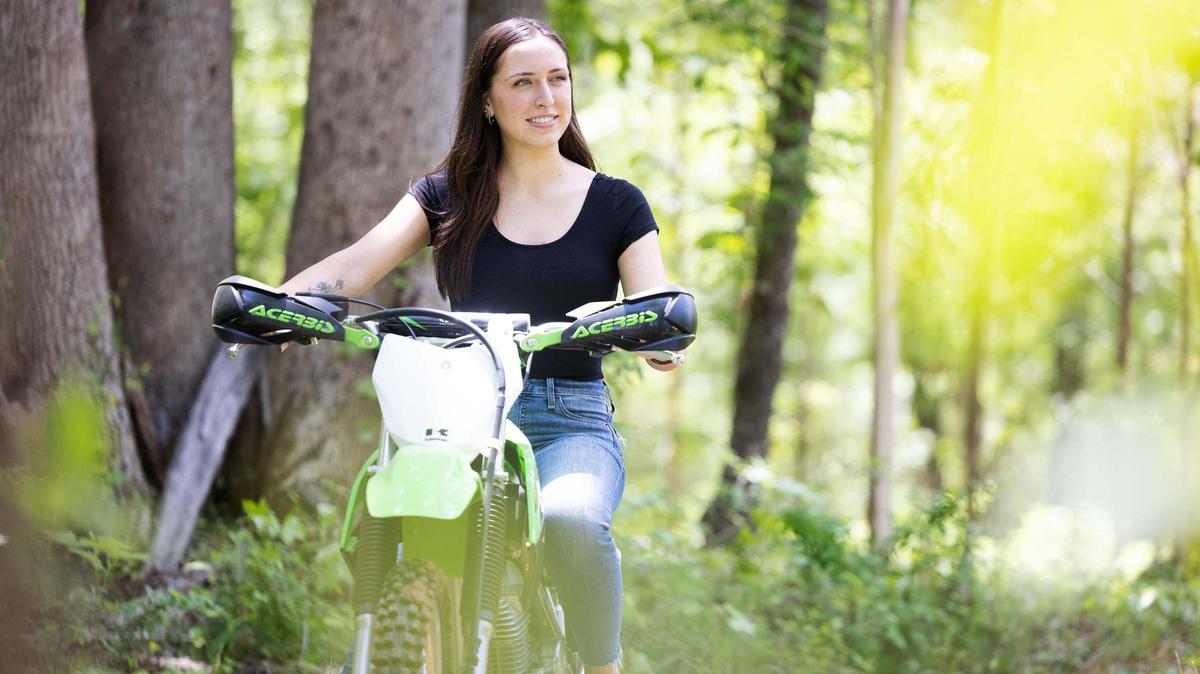 Kristiana Rigney, 20, sits on her dirt bike outside her family’s home in Mooresville Thursday, May 5, 2022. She plans to ride the bike again after her six-month recovery from surgery at Overland Park Regional Medical Center in Kansas that repaired her rapidly beating heart condition.