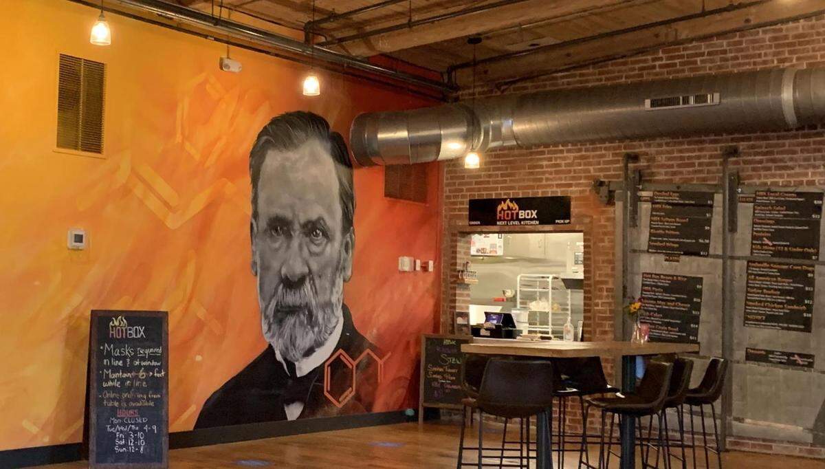 An image of Louis Pasteur overlooks the Hot Box Next Level Kitchen counter.