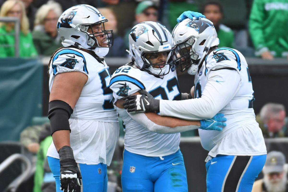 Carolina Panthers tight end Tommy Tremble, center, celebrates his touchdown catch with guard Robert Hunt, left, and offensive tackle Ikem Ekwonu (79) during the second quarter against the Philadelphia Eagles in a December 2024 game at Lincoln Financial Field. Mandatory Credit: Eric Hartline-Imagn Images