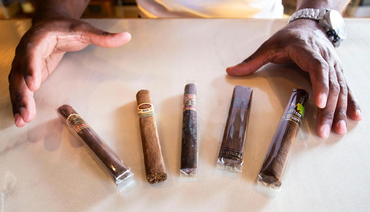 Co-owner Xavian Seiferth displays a selection of cigars.