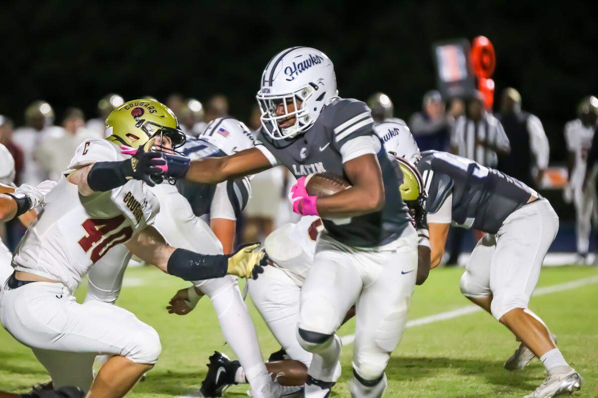 Charlotte Latin School’s De’jon Douglas stiff-arms a defender while powering up the field. The independent school is in south Charlotte. 