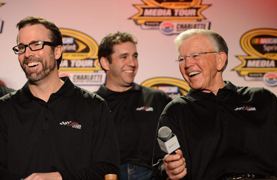 In this 2014 file photo, J.D. Gibbs (left) and his father Joe Gibbs (right) share a laugh during a media event in Charlotte. J.D. Gibbs died five years later of a degenerative neurological disease, at age 49.
