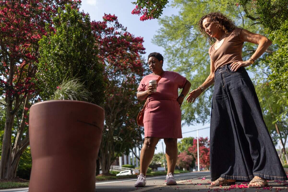 Tanya Wilson, left, and Valerie Preston, point out issues with the planters along The Plaza in the Plaza Midwood neighborhood in Charlotte, N.C., on Tuesday, June 29, 2026.
