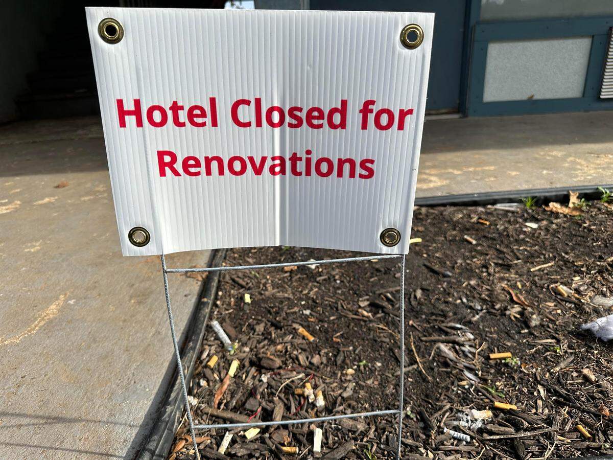 A sign at the Lamplighter Inn says the hotel is closed for renovations. Dozens of tenants were entering and exiting their rooms on Thursday afternoon.