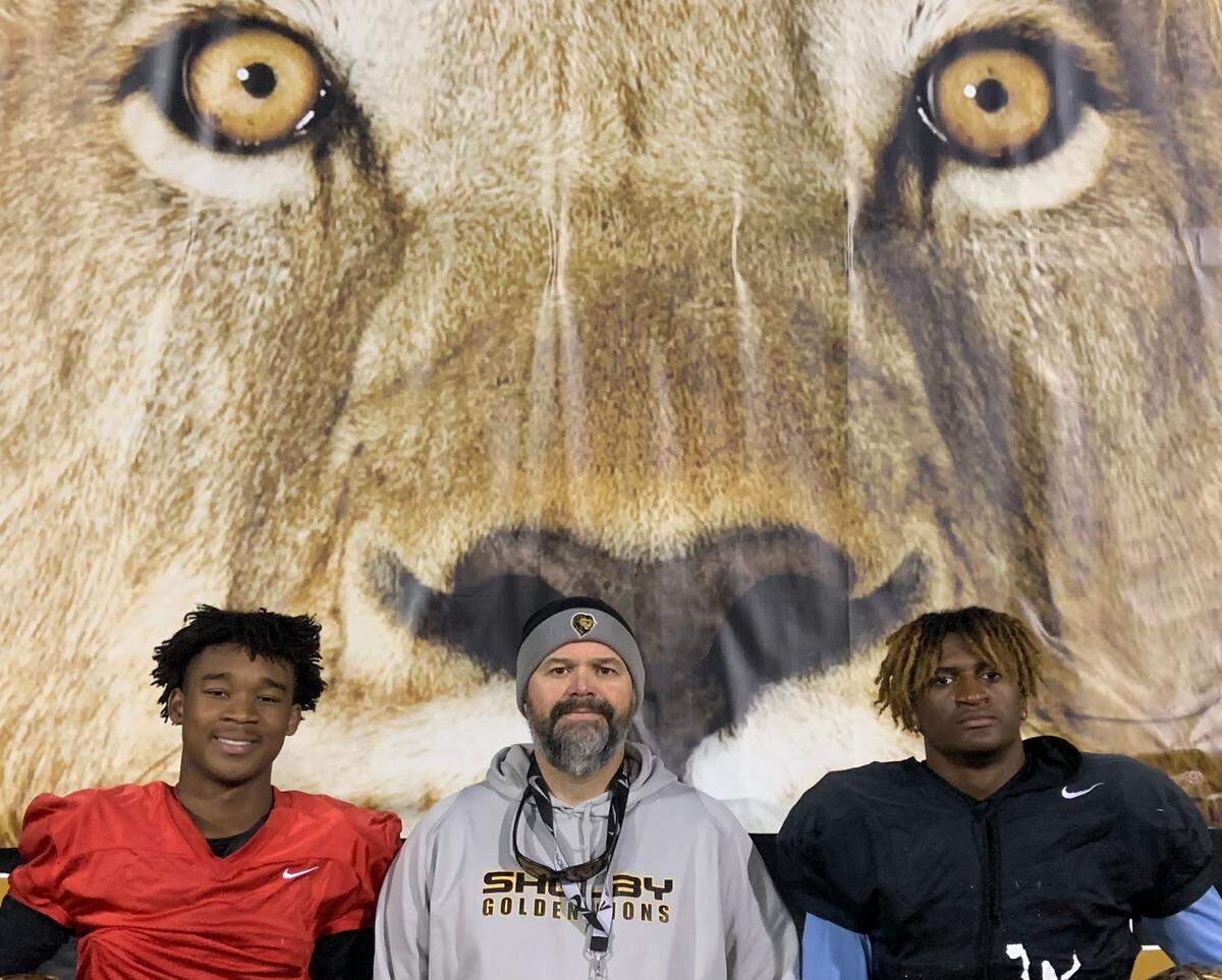 The Shelby Golden Lions are led by quarterback Daylin Lee (left), coach Mike Wilbanks (center) and linebacker Malaki Hamrick. Shelby has won six state championships in the past eight years and will play Wallace-Rose Hill in the 2A state championship game Saturday, Dec. 11, 2021, at Carter-Finley Stadium in Raleigh.