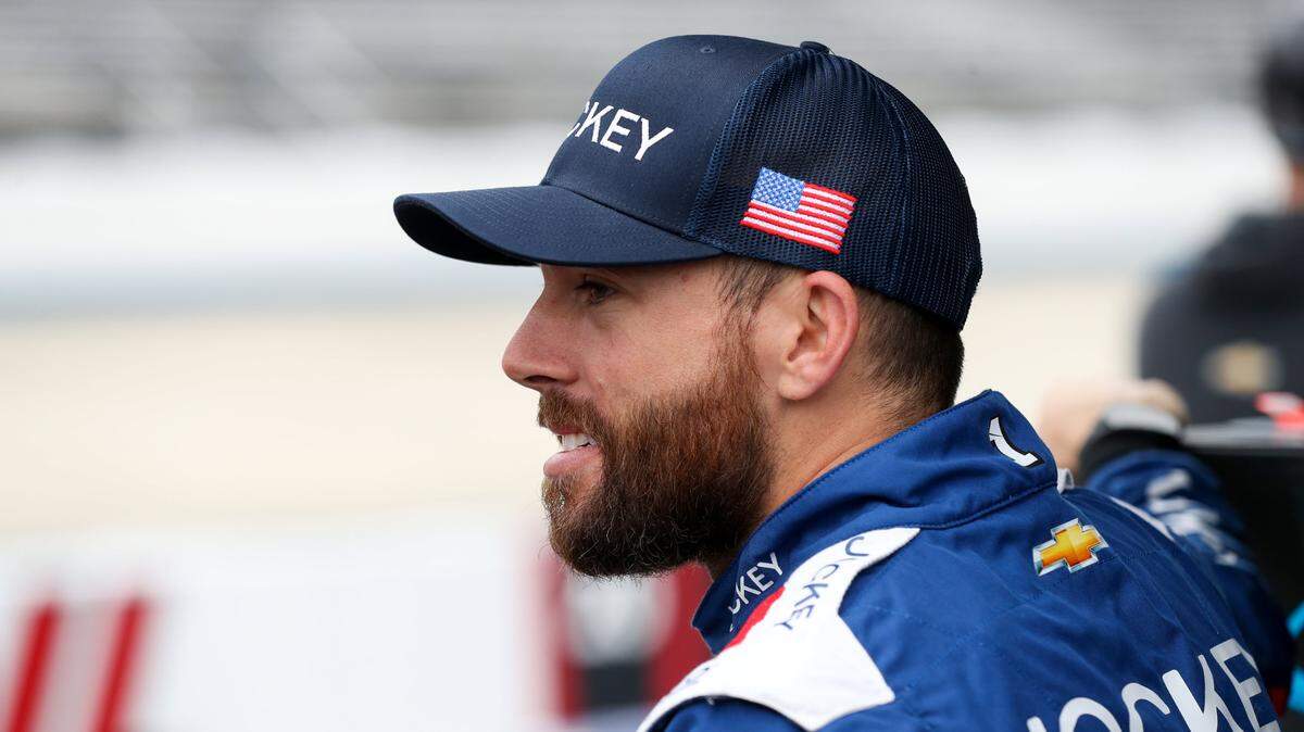 NASCAR Cup Series driver Ross Chastain stands behind the pit road wall during practice and qualifying for the Wurth 400 at Dover Motor Speedway.