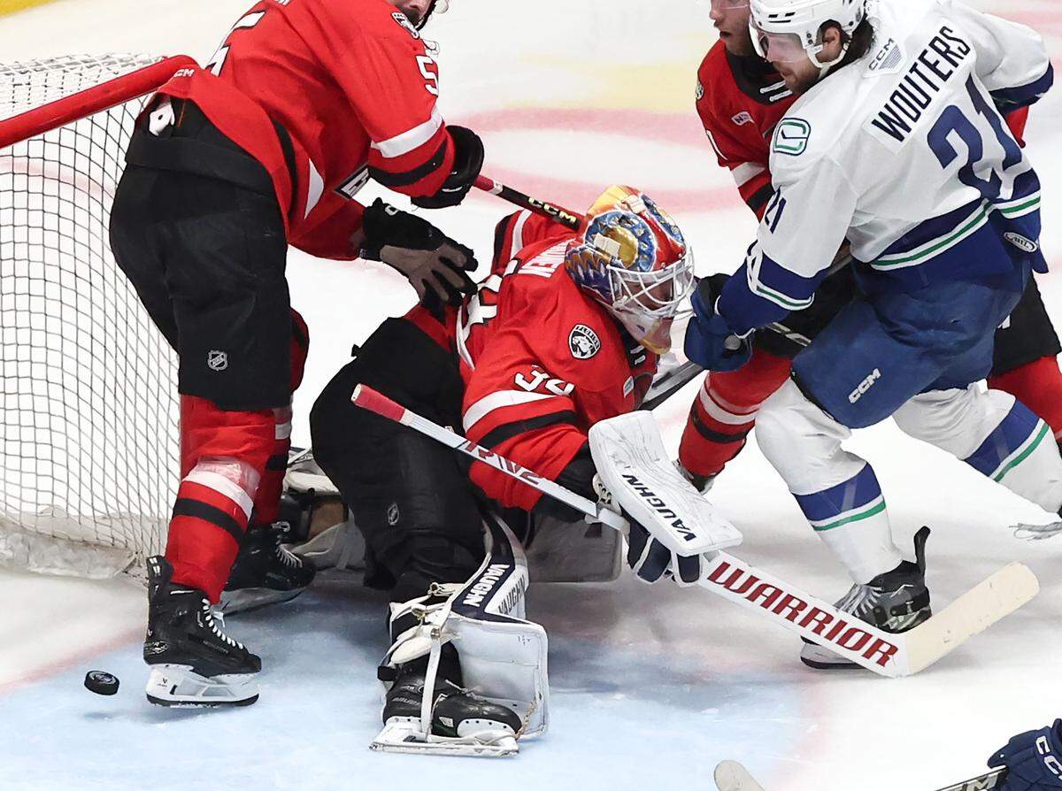 Charlotte Checkers goalie Kaapo Kahkonen, center, is unable to stop an Abbotsford Canucks shot on goal during Monday’s Game 6 of the Calder Cup finals at Bojangles Coliseum.