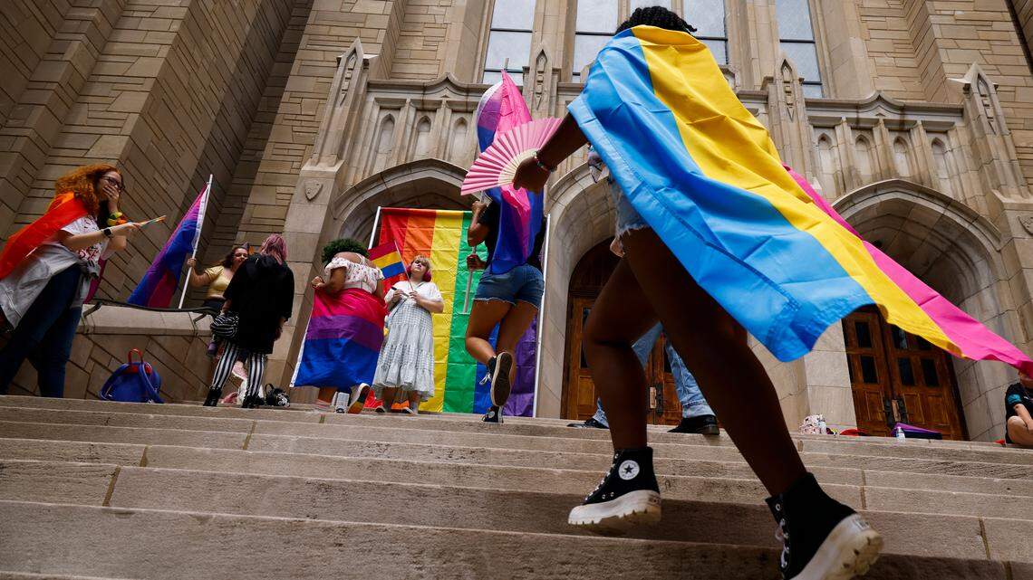 Charlotte Pride Parade attendees take pictures on the steps of the First United Methodist Church on North Tryon before the Charlotte Pride Parade through uptown, Sunday, Aug. 21, 2022.