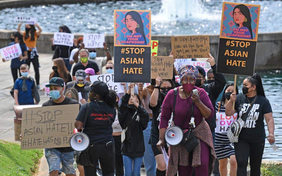 David T. Foster III's March 27 photo of rally participants marching during the "Stop Asian Hate" event at Marshall Park in Charlotte.