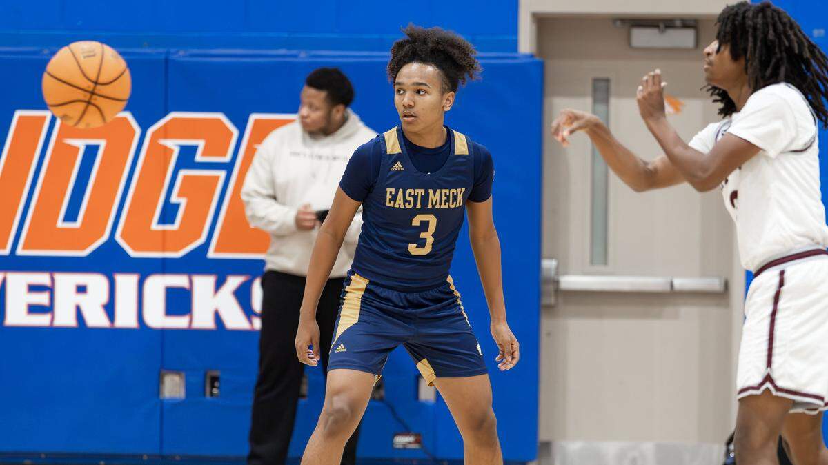 East Meck's Zavion Funderburk (3) defends the 3-point shot during late 1st quarter action. West Meck Men's basketball team would take on East Meck at the Phenom Hoops Mike Gminski Classic at Marvin Ridge High School December 27, 2025.