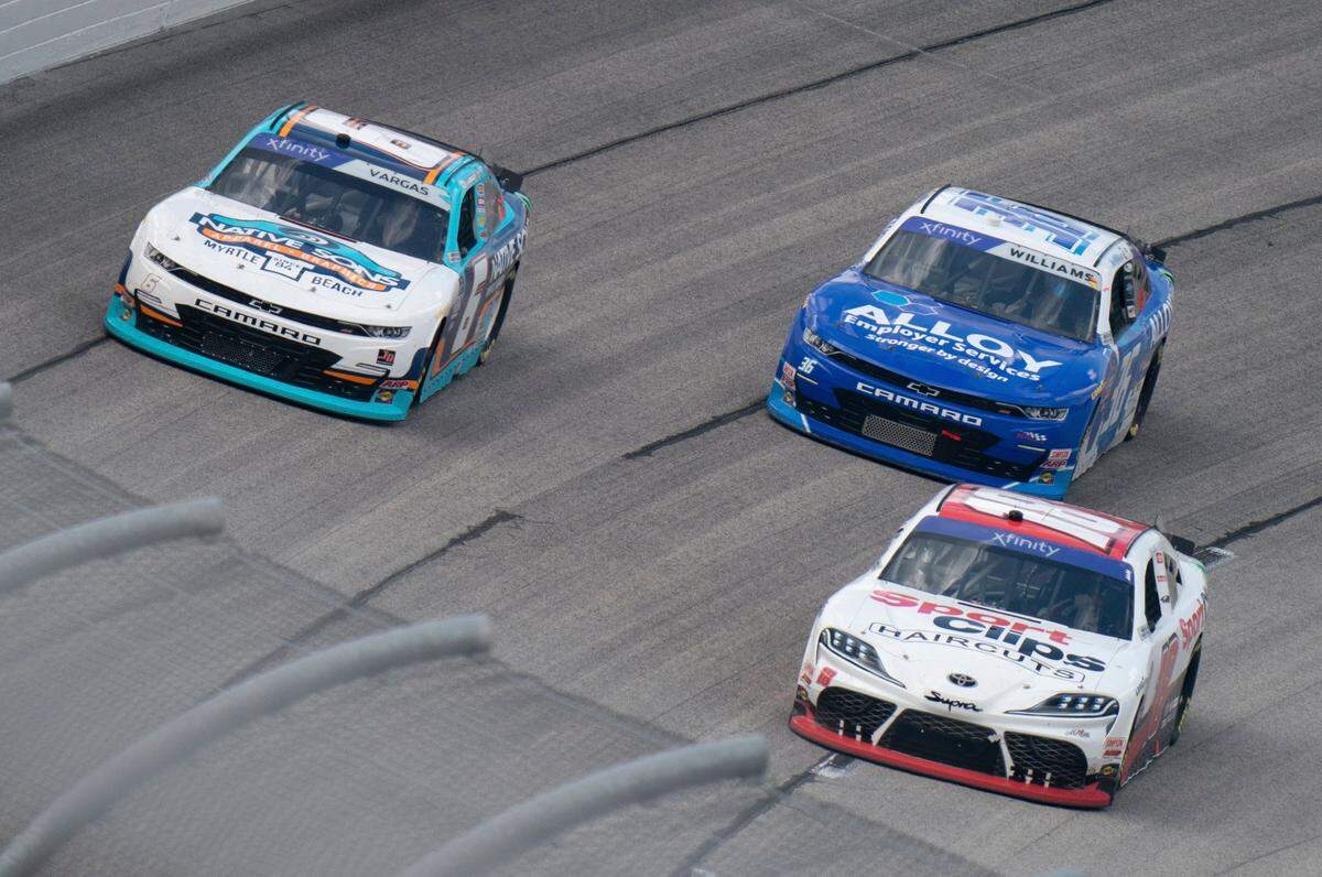 Ryan Vargas (6), Christopher Bell (18) and Josh Williams (36) drive during the NASCAR Xfinity Series auto race Saturday, Sept. 3, 2022, at Darlington Raceway in Darlington, S.C. (AP Photo/Sean Rayford)