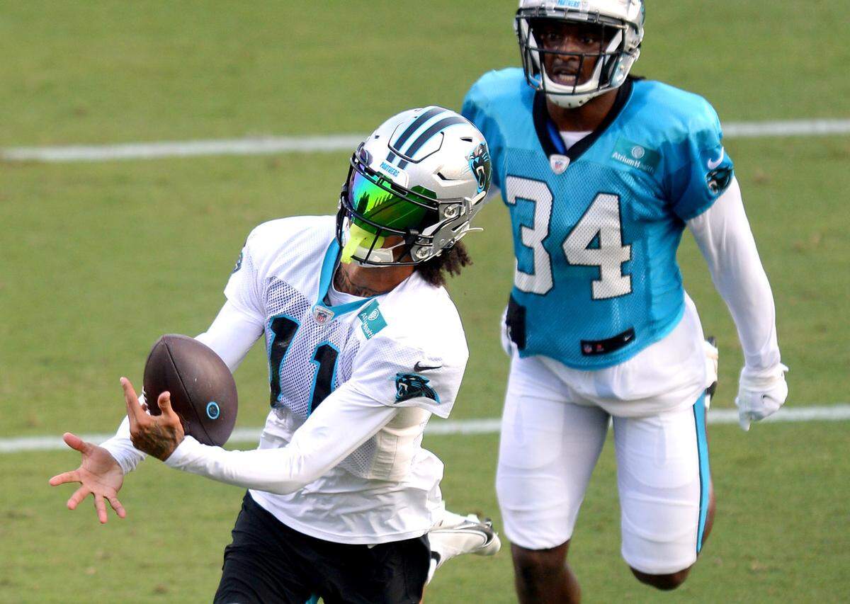 Carolina Panthers wide receiver Robby Anderson, left, reaches out to catch a pass as safety Sean Chandler, right, chases during practice at Gibbs Stadium on Saturday, July 31, 2021. The team held their practice at Gibbs Stadium as part of the NFLÕs Training Camp: Back Together Saturday celebrating the return of fans and football.