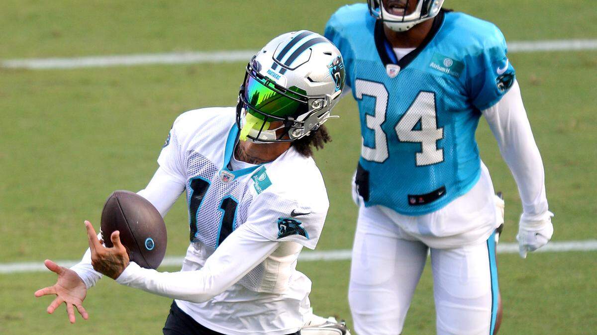Carolina Panthers wide receiver Robby Anderson, left, reaches out to catch a pass as safety Sean Chandler, right, chases during practice at Gibbs Stadium on Saturday, July 31, 2021. The team held their practice at Gibbs Stadium as part of the NFLÕs Training Camp: Back Together Saturday celebrating the return of fans and football.