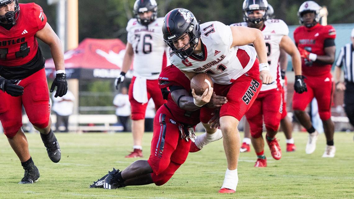 Rolesville Rams Braden Atkinson, right, is sacked by Butler Bulldogs Michael Bloomfield at Butler High School in Matthews, N.C., on Friday, August 23, 2024.