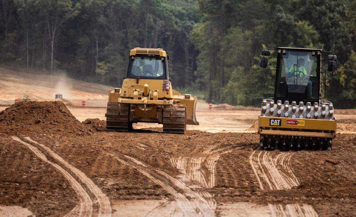 A construction crew works on the East West Connector in Mooresville, N.C., on Friday, September 13, 2024. Two years from completion, the connector has already attracted major housing subdivisions and a planned mega mixed-used community.