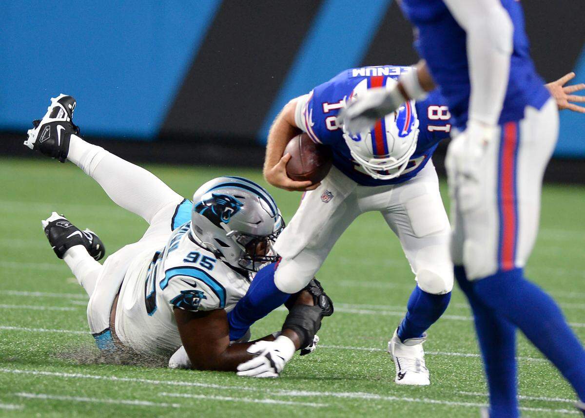Carolina Panthers defensive tackle Derrick Brown, left, sacks Buffalo Bills quarterback Case Keenum, right, at Bank of America Stadium in Charlotte, NC on Friday, August 26, 2022.