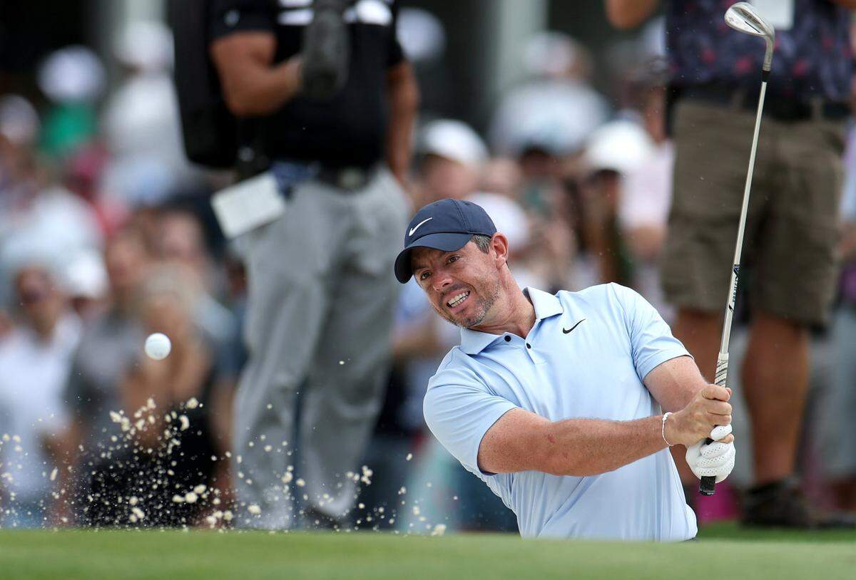 Rory McIlroy watches his ball clear the rim of a sand trap at the 10th green during second round action of the Wells Fargo Championship at Quail Hollow Club in Charlotte, NC on Friday, May 10, 2024.