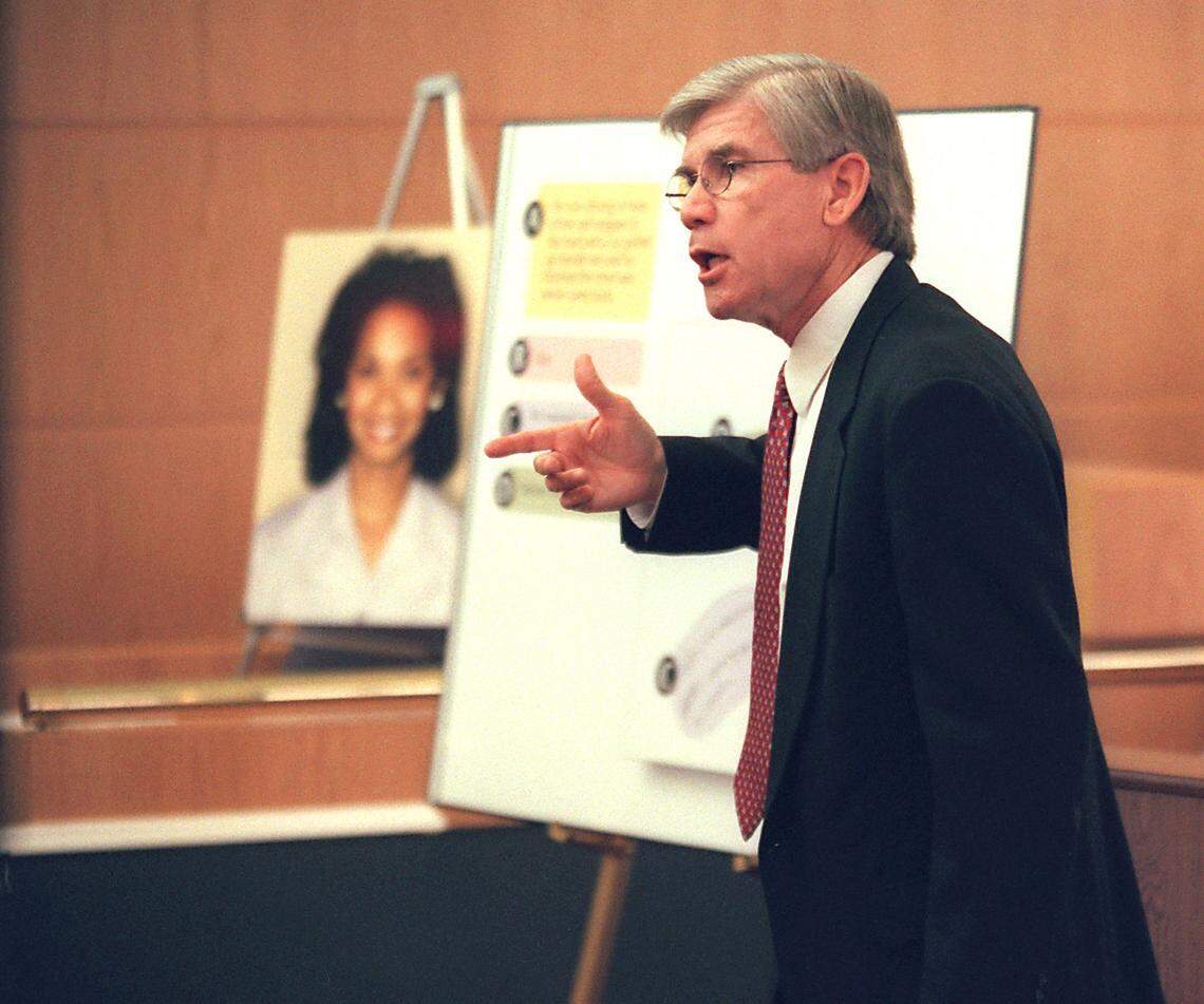 Prosecutor Gentry Caudill speaks in front of exhibits featuring handwitten notes from Cherica Adams while she was hospitalized, during closing arguments.