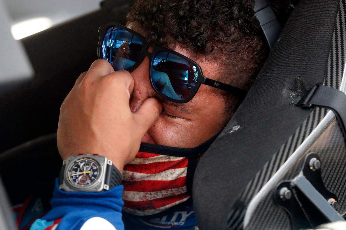 Driver Bubba Wallace is overcome with emotion as he sits in his car prior to the start of the NASCAR Cup Series auto race at Talladega, Ala., Monday. A noose was found in the garage stall of Wallace’s car Sunday.