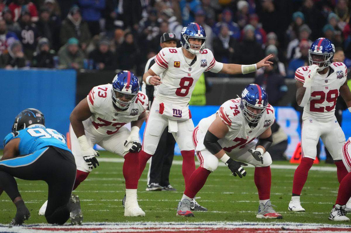 New York Giants quarterback Daniel Jones (8) prepares to take the snap against the Carolina Panthers in the first half during the 2024 NFL Munich Game at Allianz Arena.