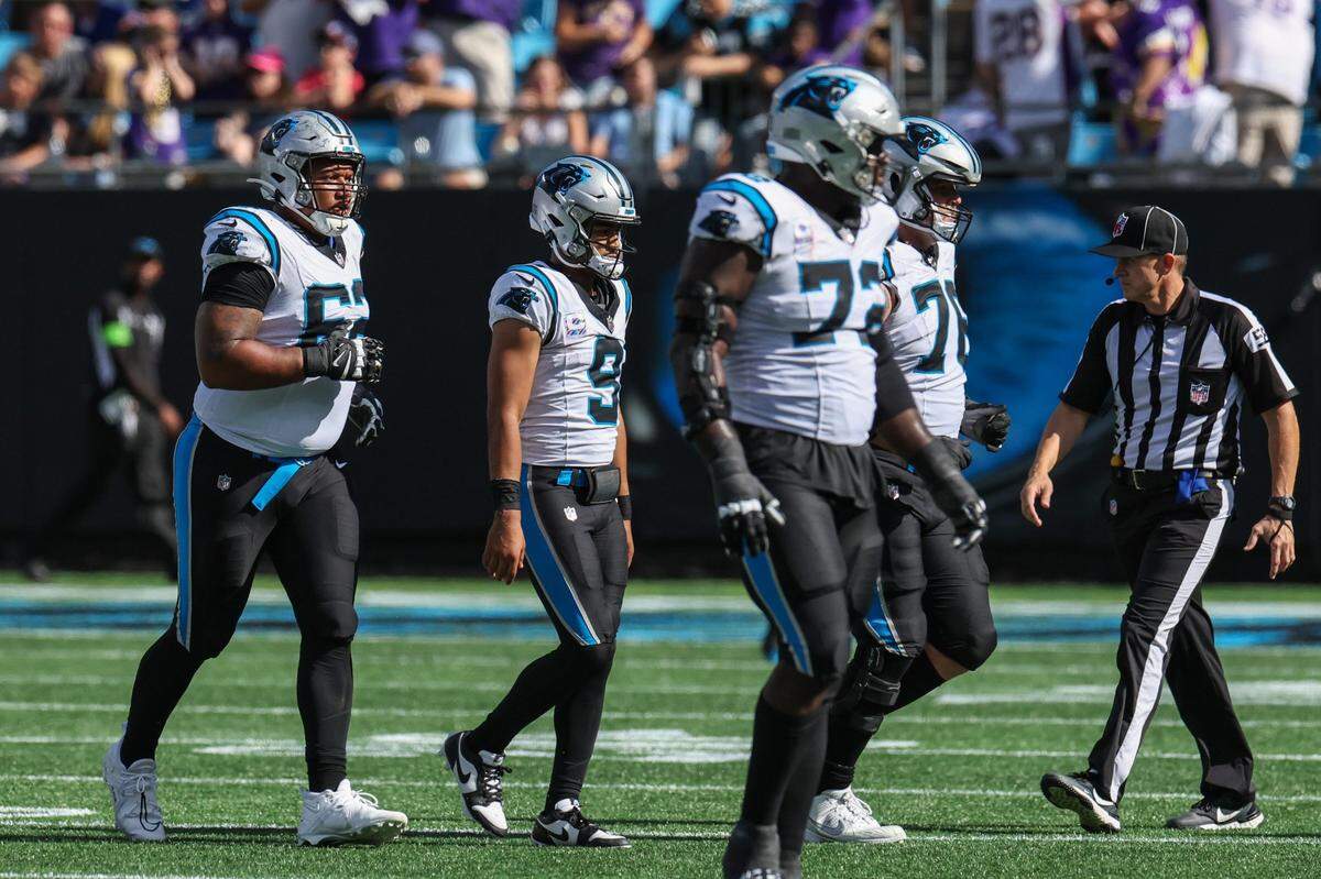 Panthers quarterback Bryce Young, center, hangs his head as he walks off the field after being sacked twice and losing possession with less than a minute left in the game against Minnesota at Bank of America Stadium on Sunday, October 1, 2023 in Charlotte, NC.
