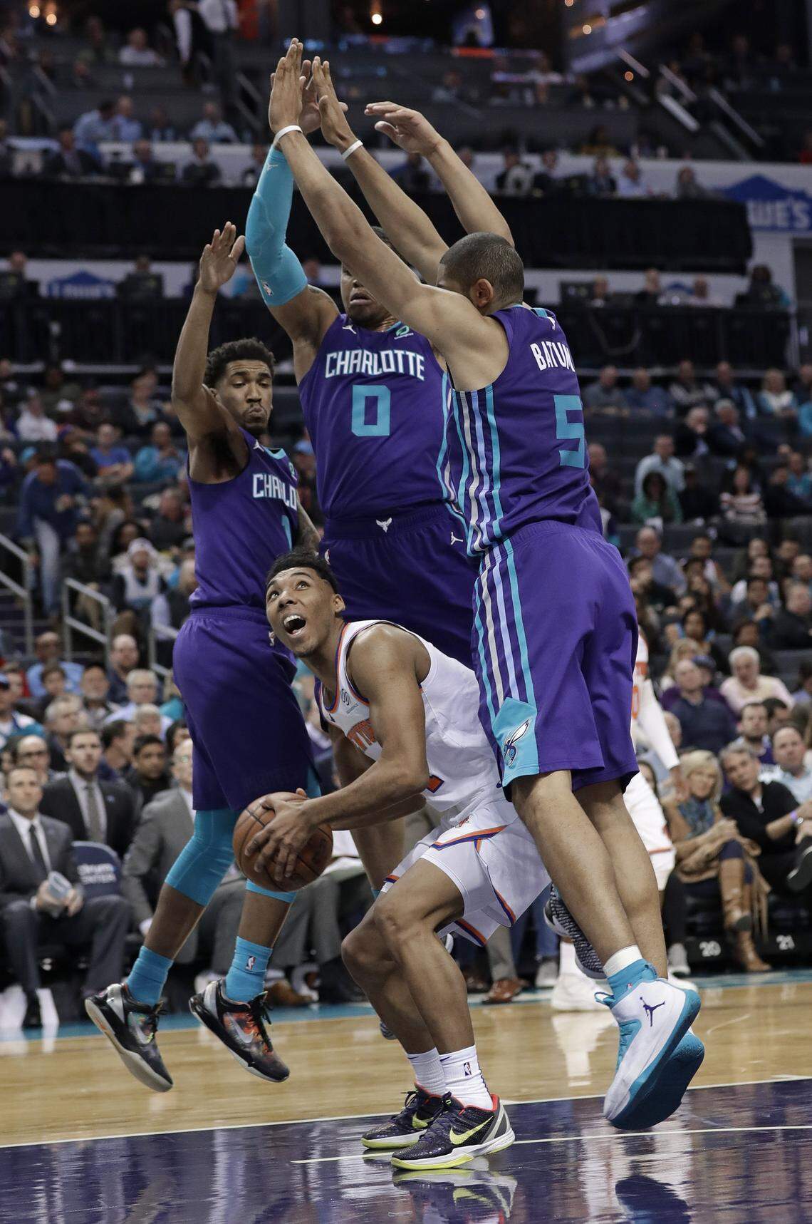 New York Knicks’ Allonzo Trier (14) is trapped by Charlotte Hornets’ Nicolas Batum (5), Miles Bridges (0), and Malik Monk (1) during the second half of an NBA basketball game in Charlotte, N.C., Monday, Jan. 28, 2019. (AP Photo/Chuck Burton)
