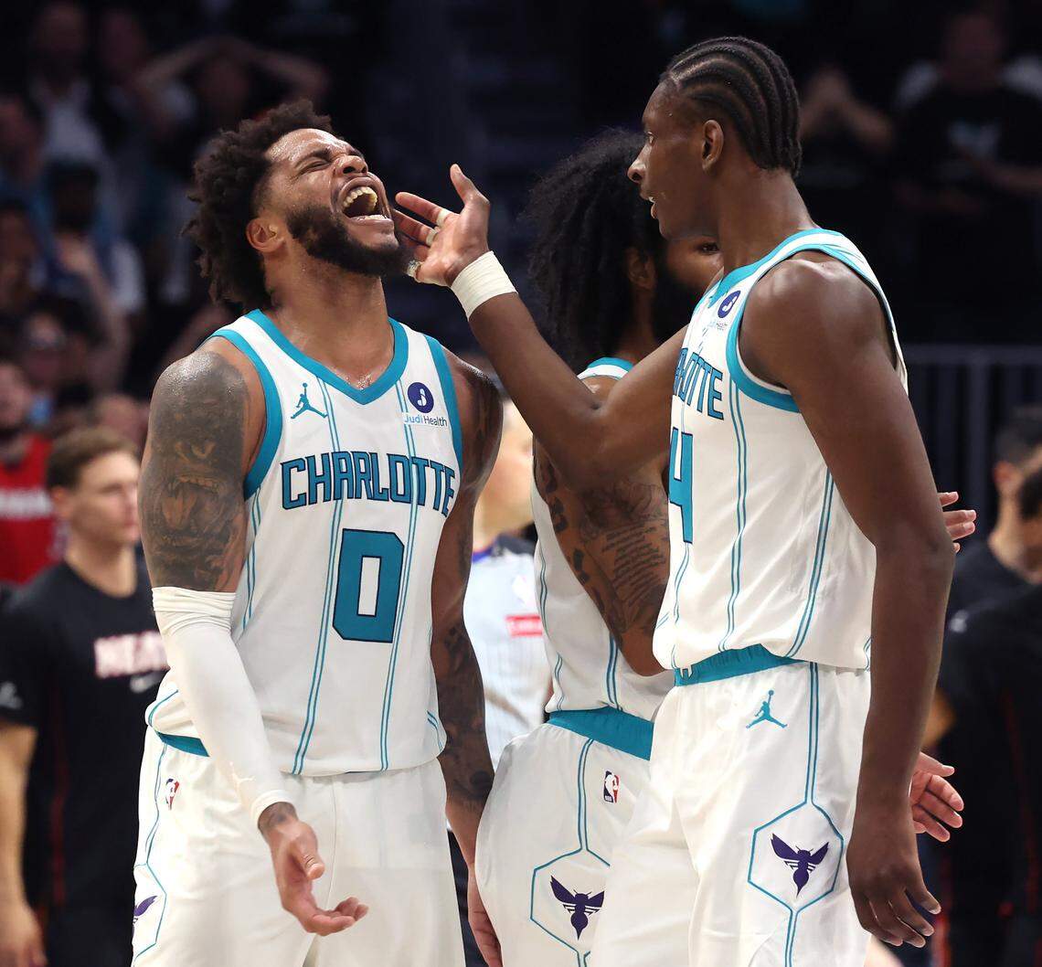 Charlotte Hornets forwards Miles Bridges, left and Moussa Diabate, right, celebrate Bridges basket during action against the Miami Heat at Spectrum Center in Charlotte, NC on Tuesday, April 14, 2026. The Hornets defeated the Heat 127-126 in NBA Play-in-Tournament basketball game.