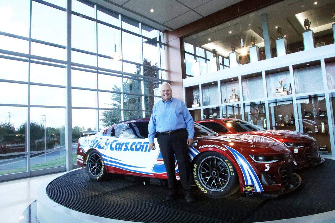 Rick Hendrick is pictured in front of two “ruby red” race cars that celebrate his company’s 40th anniversary at Hendrick Motorsports in Concord, N.C., on October 3, 2024.