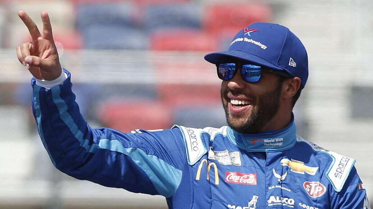Bubba Wallace waves to fans during driver introductions prior to the NASCAR Cup Series auto race at Phoenix Raceway, Sunday, March 8, 2020, in Avondale, Ariz. (AP Photo/Ralph Freso)